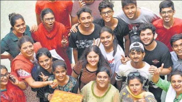 Students and teachers of Father Agnel Multipurpose School and Junior College in Vashi celebrate the HSC results on Tuesday.(HT photo)