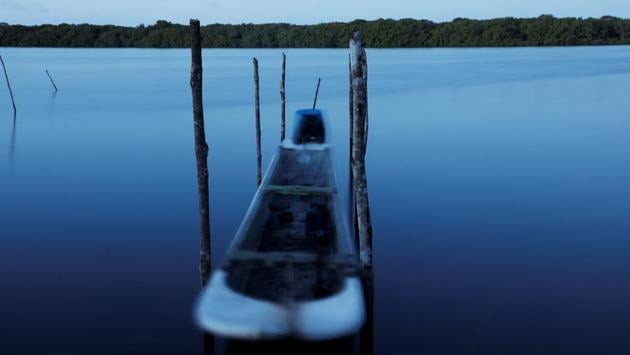 Climate scientists lend credence to Cruz’s interpretation of what he sees. Rising water levels, they say, are a sign of global warming, which also causes water temperatures to rise, killing off some marine life. These changes in turn are threatening the families in Cruz’s village that depend on the coastal ecosystem. (Nacho Doce / REUTERS) 