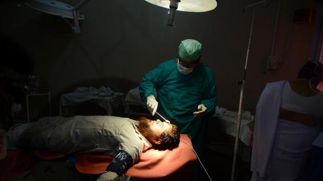 Sabir Ali, an impoverished weaver who got a card for himself and his family to use at any of the 15,000-odd participating hospitals, had a cyst removed from his forehead. “It was unbelievable to hold the card in my hands,” Ali told AFP, his head bandaged at the Sitapur district hospital. “I used the card and I didn’t have to spend a single rupee on my treatment.” (Sanjay Kanojia / AFP) Sabir Ali, an impoverished weaver who got a card for himself and his family to use at any of the 15,000-odd participating hospitals, had a cyst removed from his forehead. “It was unbelievable to hold the card in my hands,” Ali told AFP, his head bandaged at the Sitapur district hospital. “I used the card and I didn’t have to spend a single rupee on my treatment.” (Sanjay Kanojia / AFP)