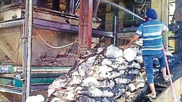 A firefighter dousing the flames after a blast in a factory in Sirhind.(HT Photo) A firefighter dousing the flames after a blast in a factory in Sirhind.(HT Photo)