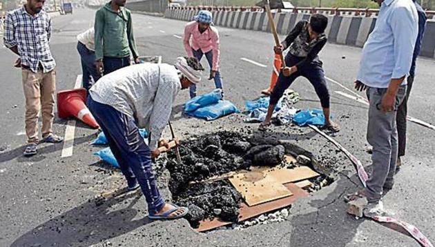 Workers repair a portion of the Hero Honda Chowk flyover that was damaged on May 8 for the second time in a year.(HT File Photo)