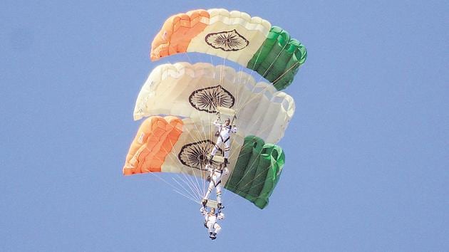 Air show by paratroopers of the Akash Ganga team during the convocation ceremony of 136th National Defence Academy (NDA) course on Wednesday.(Milind Saurkar/HT Photo)