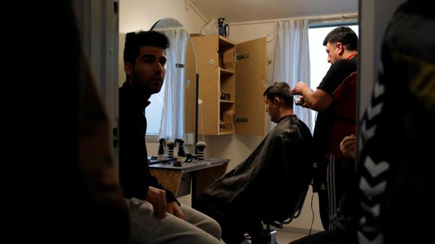 Residents line up to have a free haircut by Behzad Moradi, who was a hairdresser in Iran for 13 years. The views of the public and the state hardened from 2015 with the arrival of large groups of refugees from conflicts in the Middle East. Similar changes in public attitude have led to tougher laws across the EU, and moves to drastically reduce the number of refugees reaching in the first place. (Andrew Kelly / REUTERS) Residents line up to have a free haircut by Behzad Moradi, who was a hairdresser in Iran for 13 years. The views of the public and the state hardened from 2015 with the arrival of large groups of refugees from conflicts in the Middle East. Similar changes in public attitude have led to tougher laws across the EU, and moves to drastically reduce the number of refugees reaching in the first place. (Andrew Kelly / REUTERS)