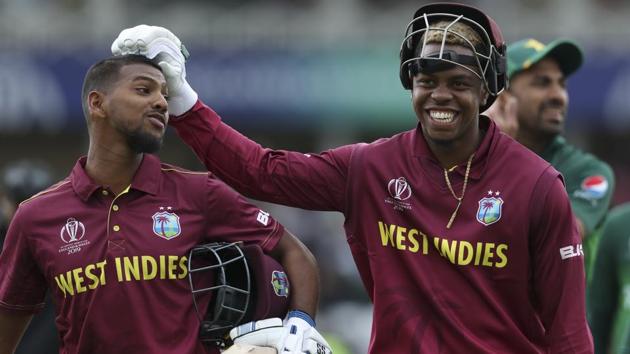 West Indies' Nicholas Pooran, left, and teammate Shimron Hetmyere leave the field after beating Pakistan by 7 wickets. (AP) 
