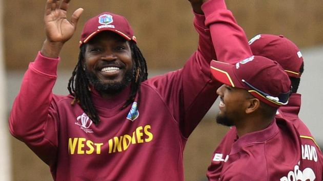 West Indies' Chris Gayle (L) celebrates taking the catch to dismiss Pakistan's Imad Wasim.(AFP)