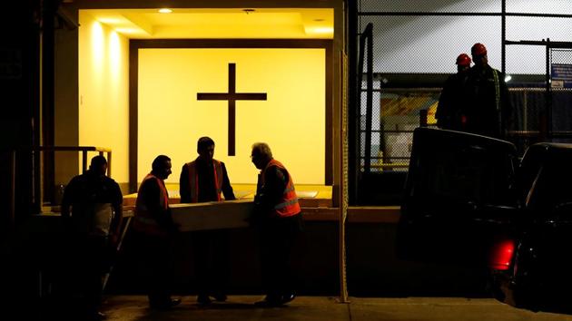 Staff of a funeral parlour load a casket containing the body of 2-1/2-year-old Guatemalan migrant Wilmer Josue Ramirez, who was detained last month at the US-Mexico border but released from US custody with his mother during treatment for an illness, into a funeral hearse at La Aurora International Airport in Guatemala City, Guatemala. (Luis Echeverria / REUTERS)