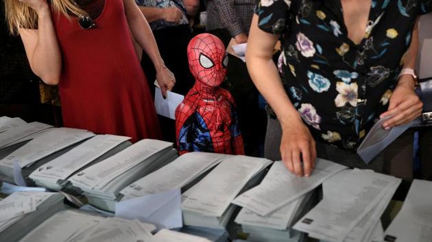 A kid in a Spiderman costume stands next to a ballot table for the European Parliament election at a polling station in Madrid, Spain. (Susana Vera / REUTERS)