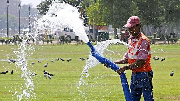 A-worker-waters-a-lawn-near-India-Gate-in-the-scorching-heat-of-New-Delhi-HT-Photo