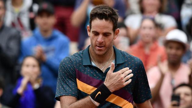 Argentina's Juan Martin del Potro makes the sign of the cross as he celebrates after winning against Japan's Yoshihito Nishioka during their men's singles second round match on day five of The Roland Garros 2019 French Open tennis tournament in Paris on May 30, 2019.(AFP)