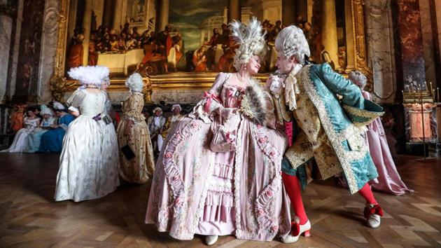 An Italian Venetian couple dressed in period costumes pose as they take part in the “Fetes Galantes” fancy dress evening at the Chateau de Versailles in France. (Ludivoc Marin / AFP)