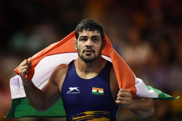 India's Kumar Sushil celebrats with his flag after wrestling against South Africa's Jahannes Botha during the men's freestyle 74 kg gold medal wrestling match at the 2018 Gold Coast Commonwealth Games in the Carrara Sports Arena on the Gold Coast on April 12, 2018.(AFP) India's Kumar Sushil celebrats with his flag after wrestling against South Africa's Jahannes Botha during the men's freestyle 74 kg gold medal wrestling match at the 2018 Gold Coast Commonwealth Games in the Carrara Sports Arena on the Gold Coast on April 12, 2018.(AFP)
