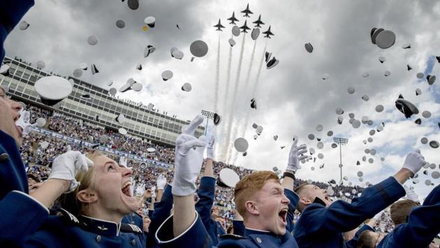 United States Air Force Academy cadets toss their hats in the air as the Thunderbirds fly overhead during the cadets’ graduation ceremony at Falcon Stadium, in Colorado Springs, Colorado. (Andrew Harnik / AP)