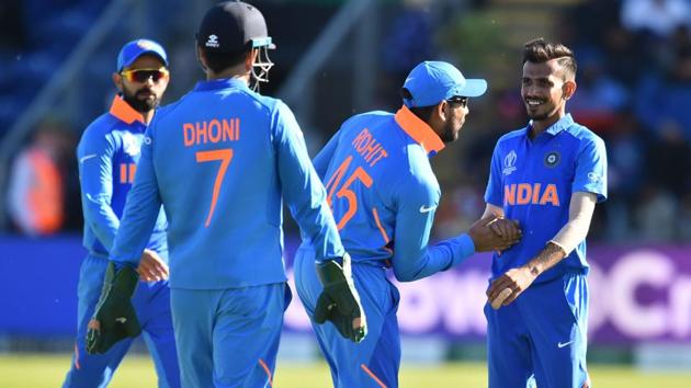 India's Yuzvendra Chahal (R) celebrates with Rohit Sharma (2R) after taking the wicket of Bangladesh's Mohammad Mithun.(AFP)