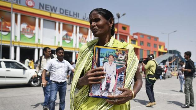 Bina Diggar, 55, holds a photograph of her husband Matal Diggar who was allegedly killed in political violence in West Bengal as she arrives to attend Prime Minister Narendra Modi’s swearing-in ceremony. (Biplov Bhuyan / HT Photo) Bina Diggar, 55, holds a photograph of her husband Matal Diggar who was allegedly killed in political violence in West Bengal as she arrives to attend Prime Minister Narendra Modi’s swearing-in ceremony. (Biplov Bhuyan / HT Photo)