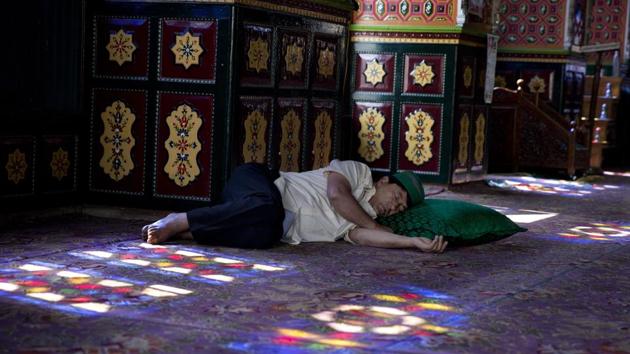 A man takes a nap inside the shrine of Sufi saint Shiekh Abdul Qadir Jeelani during the holy fasting month of Ramzan in Srinagar, Jammu and Kashmir. Muslims across the world are observing the holy fasting month of Ramadan, where they refrain from eating, drinking and smoking from dawn to dusk. (Yasin Dar / AP) A man takes a nap inside the shrine of Sufi saint Shiekh Abdul Qadir Jeelani during the holy fasting month of Ramzan in Srinagar, Jammu and Kashmir. Muslims across the world are observing the holy fasting month of Ramadan, where they refrain from eating, drinking and smoking from dawn to dusk. (Yasin Dar / AP)