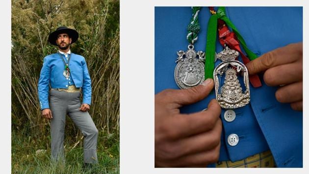 Alberto Simon, a devotee, poses while taking part in the “Romeria de El Rocio” and points to a medallion he was wearing with the image of the Virgin while walking in the procession. (Alvaro Barrientos / AP) Alberto Simon, a devotee, poses while taking part in the “Romeria de El Rocio” and points to a medallion he was wearing with the image of the Virgin while walking in the procession. (Alvaro Barrientos / AP)