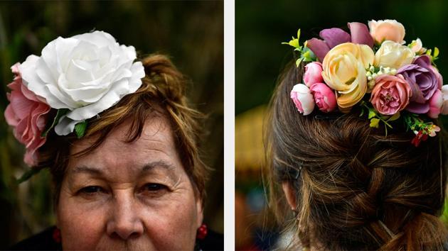 Josefa Daza (L) and an unnamed devotee (R) wearing flower fascinators in their hair. Now the devotees in the yearly procession are a mix of people whose families hail from the south and those who have adopted the pilgrimage as their own. (Alvaro Barrientos / AP) Josefa Daza (L) and an unnamed devotee (R) wearing flower fascinators in their hair. Now the devotees in the yearly procession are a mix of people whose families hail from the south and those who have adopted the pilgrimage as their own. (Alvaro Barrientos / AP)