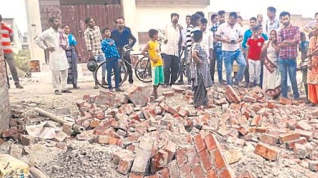 The debris of the collapsed wall of the under-construction house in the Mundian area of Ludhiana on Saturday. Seven-year-old Nitish Kumar and his four-year-old sister Syali were killed in the incident. (/HT Photo) The debris of the collapsed wall of the under-construction house in the Mundian area of Ludhiana on Saturday. Seven-year-old Nitish Kumar and his four-year-old sister Syali were killed in the incident. (/HT Photo)