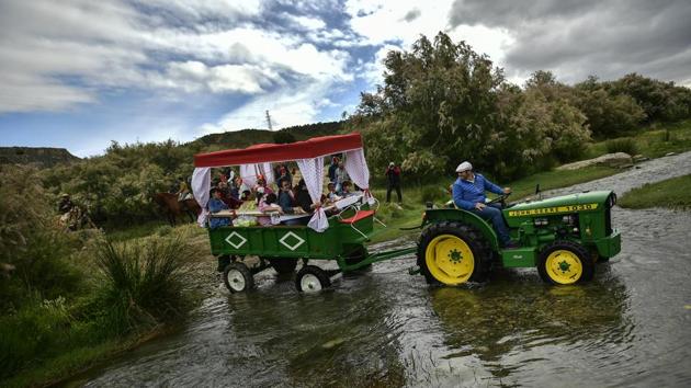 Devotees of the Rocio Virgin cross a river as they take part in the “Romeria de El Rocio”. Hundreds of Spaniards slowly make their way on foot, horseback or on carriages drawn by mules or tractors through the fields around the agricultural town of Fitero near Pamplona, the city famous for its running of the bulls fiesta. (Alvaro Barrientos / AP) Devotees of the Rocio Virgin cross a river as they take part in the “Romeria de El Rocio”. Hundreds of Spaniards slowly make their way on foot, horseback or on carriages drawn by mules or tractors through the fields around the agricultural town of Fitero near Pamplona, the city famous for its running of the bulls fiesta. (Alvaro Barrientos / AP)