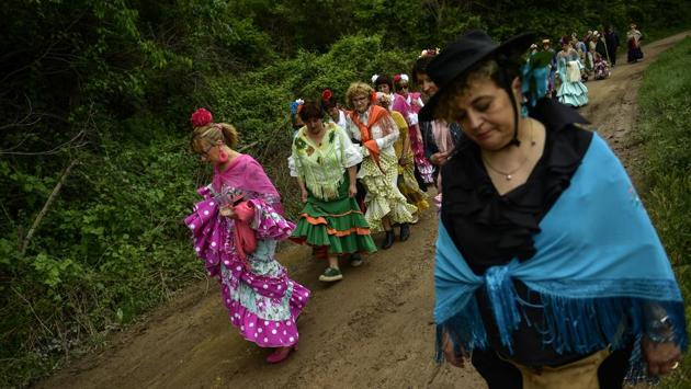The devotees stroll in a long line along narrow dirt roads through lush fields accompanying a mule-drawn cart that bears a small wooden statue of the Virgin and Child. They occasionally stop to dance to add to the festive atmosphere. (Alvaro Barrientos / AP) The devotees stroll in a long line along narrow dirt roads through lush fields accompanying a mule-drawn cart that bears a small wooden statue of the Virgin and Child. They occasionally stop to dance to add to the festive atmosphere. (Alvaro Barrientos / AP)