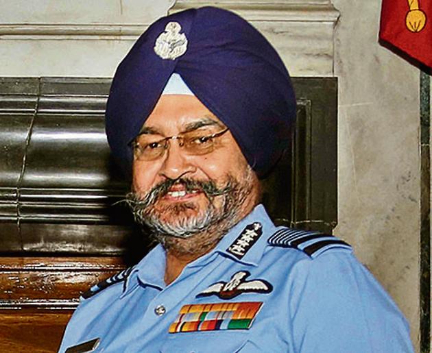 Chief of the Air Staff, Air Chief Marshal BS Dhanoa, receives the Chairman Chiefs of Staff Committee (COSC) baton from outgoing Chief of the Naval Staff Admiral Sunil Lanba in a ceremony, at South Block in New Delhi.(PTI file photo)