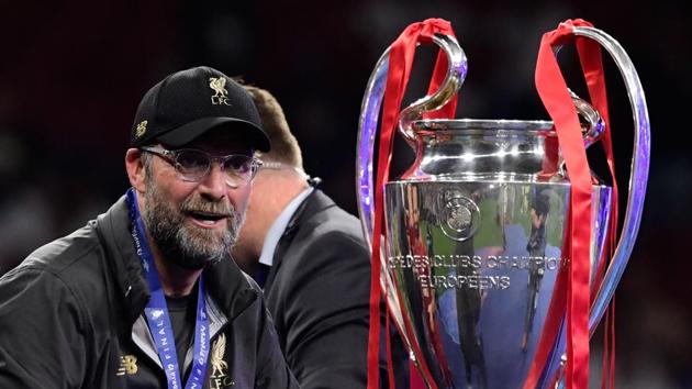 TOPSHOT - Liverpool's German manager Jurgen Klopp looks at the trophy after winning the UEFA Champions League final football match between Liverpool and Tottenham Hotspur at the Wanda Metropolitano Stadium in Madrid on June 1, 2019. (AFP) TOPSHOT - Liverpool's German manager Jurgen Klopp looks at the trophy after winning the UEFA Champions League final football match between Liverpool and Tottenham Hotspur at the Wanda Metropolitano Stadium in Madrid on June 1, 2019. (AFP)