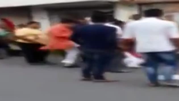 In this grab from the video that went viral, BJP MLA Balram Thawani (R) can be seen kicking Nitu Tejwani (L) who has fallen down on the road after being assaulted while she had gone to report about the water supply issue in her area. (Twitter/ANI/Video grab from ANI) In this grab from the video that went viral, BJP MLA Balram Thawani (R) can be seen kicking Nitu Tejwani (L) who has fallen down on the road after being assaulted while she had gone to report about the water supply issue in her area. (Twitter/ANI/Video grab from ANI)