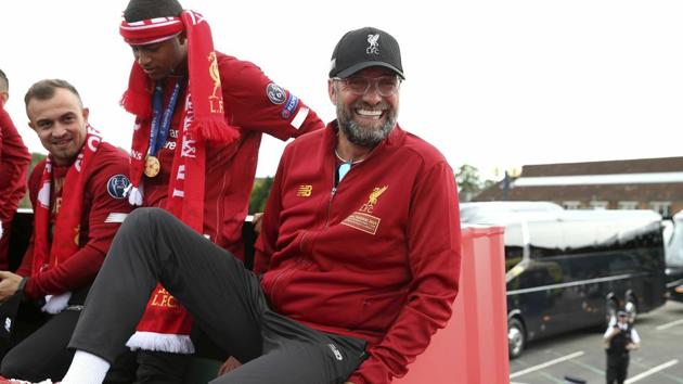 Liverpool soccer team manager Jurgen Klopp, rides an open top bus during the Champions League Cup Winners Parade in Liverpool, England, Sunday June 2, 2019. Liverpool is champion of Europe for a sixth time after beating Tottenham 2-0 in the Champions League final played in Madrid Saturday(AP)