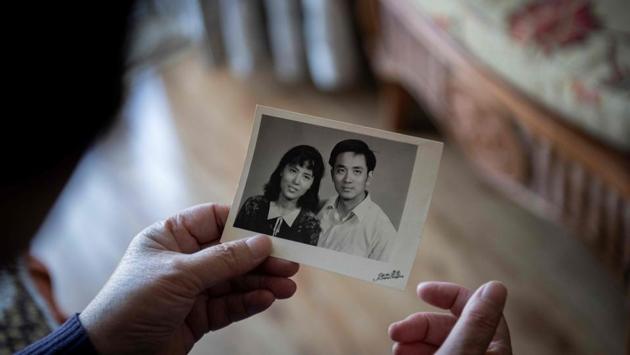 You Weijie, 66, looks at a photograph of her and husband Yang Minghu, in Beijing on April 10, 2019. Three decades later, relatives of the victims are still demanding to know the truth about the most taboo subject in modern Chinese history. Her husband Yang Minghu, an office worker, was not a demonstrator, but he ended up among the hundreds who died. (Nicolas Asfouri / AFP)