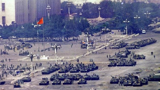 Chinese troops and tanks gather in Beijing, one day after the military crackdown on June 5, 1989. A day later, Chinese State Council spokesman Yuan Mu said on television that the known death toll was about 300, most of them soldiers with only 23 students confirmed killed. China has never provided a full death toll, but rights groups and witnesses say the figure could run into the thousands. (Jeff Widener / AP File)