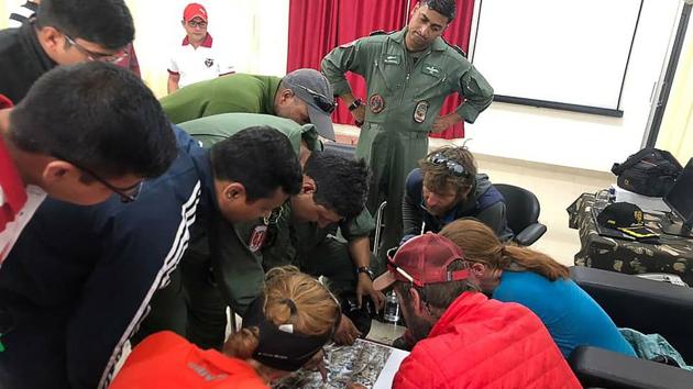 Rescued mountaineers look at a an aerial picture along with rescue personnel upon arriving to a Indo-Tibetan Border Police camp in Pithoragarh. Rescuers onboard an IAF helicopter spotted the bodies of five of the eight mountaineers missing in an avalanche since May 25, near an unnamed peak adjoining Nanda Devi East peak in Uttarakhand on Monday, officials said. (ITBP / AFP) Rescued mountaineers look at a an aerial picture along with rescue personnel upon arriving to a Indo-Tibetan Border Police camp in Pithoragarh. Rescuers onboard an IAF helicopter spotted the bodies of five of the eight mountaineers missing in an avalanche since May 25, near an unnamed peak adjoining Nanda Devi East peak in Uttarakhand on Monday, officials said. (ITBP / AFP)