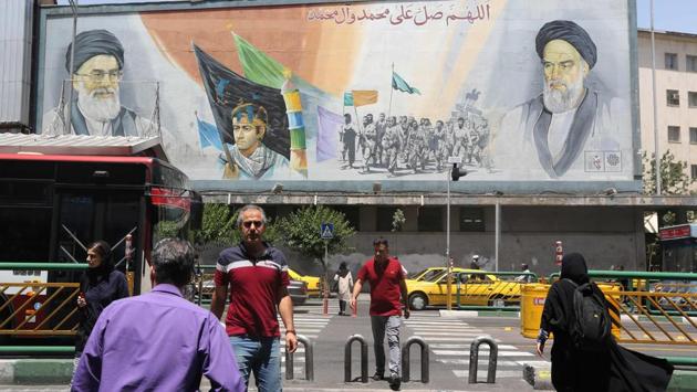 Pedestrians walk in front of a mural painting Ayatollah Khomeini (R) and Iran’s supreme leader Ayatollah Ali Khamenai in Tehran. Khomeini “literally changed Iranian society, (from) a country that was subservient to the needs and interests of foreign entities to prioritising the needs, the dignity, beliefs, culture and the interests of the indigenous population,” said Marandi from Tehran University. (Atta Kenare / AFP) Pedestrians walk in front of a mural painting Ayatollah Khomeini (R) and Iran’s supreme leader Ayatollah Ali Khamenai in Tehran. Khomeini “literally changed Iranian society, (from) a country that was subservient to the needs and interests of foreign entities to prioritising the needs, the dignity, beliefs, culture and the interests of the indigenous population,” said Marandi from Tehran University. (Atta Kenare / AFP)