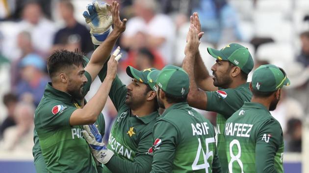 Pakistan's Mohammad Amir, left, celebrates with teammates the dismissal of England's Jofra Archer. (AP)
