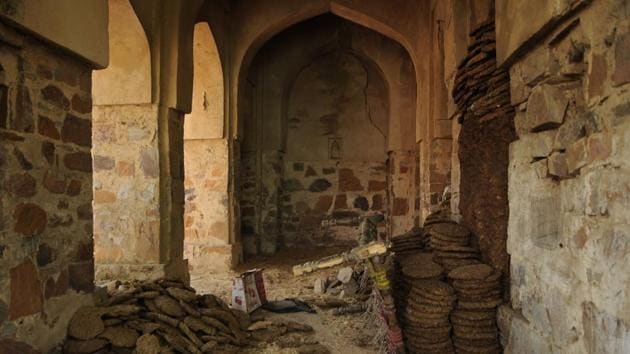 Remnants of the conflict can still be found on the mosque, with faint remains of the word “mandir” written in Devanagari still visible on its dome. While most residents know about the conflict, they are unaware about the historicity of the mosque. The pavilions of the mosque continue to be used for storing cow dung cakes. (Parveen Kumar / HT Photo) 