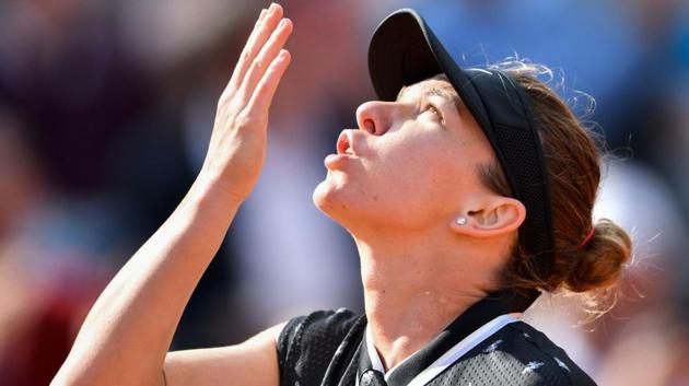 Romania's Simona Halep celebrates after winning against Poland's Iga Swiatek.(AFP)