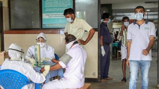 Doctors and patients wear safety masks as a precautionary measure after the 'Nipah' virus outbreak, at a Medical college, in Kozhikode, on Wednesday.(PTI File Photo)