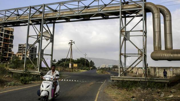 A motorist travels under a Bharat Petroleum Corp. LPG pipeline. The White House announcement came just a day after PM Narendra Modi was sworn into a second term. Trump’s decision was a “double whammy” after the nation “succumbed to US pressure” by not buying crude oil from Iran on favorable terms, Randeep Surjewala, chief spokesman of the Congress Party, said Saturday, according to the Economic Times. (Dhiraj Singh / Bloomberg)