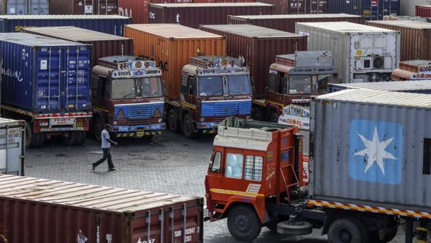 A man walks past container trucks sitting parked near the Jawaharlal Nehru Port, in Navi Mumbai, Maharashtra. “I have determined that India has not assured the United States that India will provide equitable and reasonable access to its markets,” Trump said in a proclamation on May 31. 2019. “Accordingly, it is appropriate to terminate India’s designation as a beneficiary developing country effective June 5, 2019.” (Dhiraj Singh / Bloomberg)