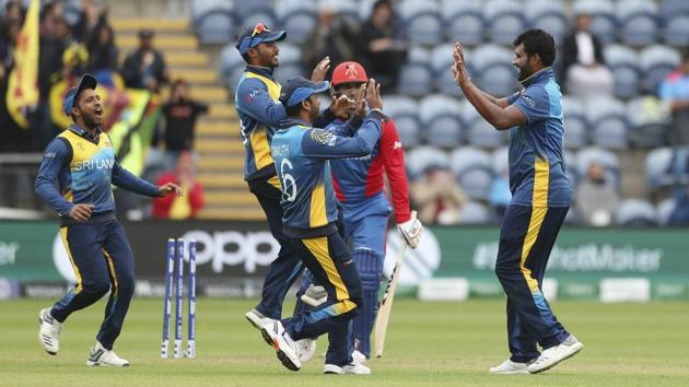 Sri Lanka's Thisara Perera is congratulated by his team mates after taking the wicket of Afghanistan's Mohammad Nabi(AP)