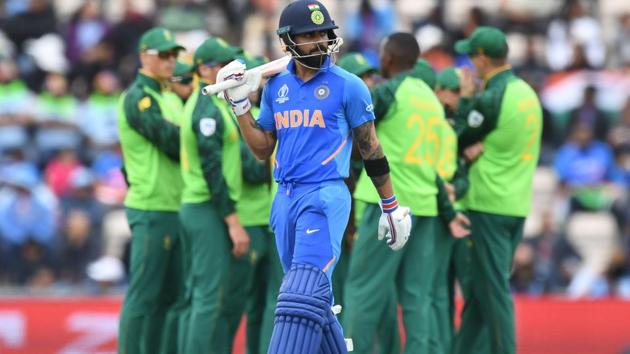 India's captain Virat Kohli walks past South Africa's players. (AFP)