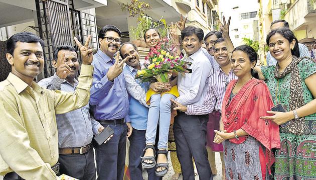 Sanskruti Chude, a science student from Modern College of Arts, Science and Commerce who scored 99.96 per cent in MHT ECT exam celebrates with teachers and family on Monday. She prefers to take admission in College of Engineering Pune. Sanskruti Chude, a science student from Modern College of Arts, Science and Commerce who scored 99.96 per cent in MHT ECT exam celebrates with teachers and family on Monday. She prefers to take admission in College of Engineering Pune.