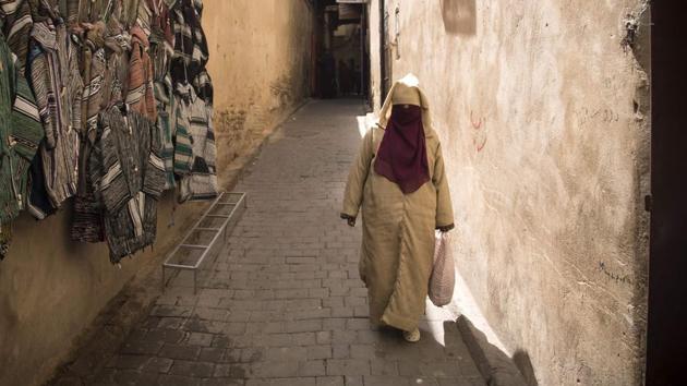 A woman walks in the 9th century walled medina. Guardian of priceless treatises in Islamic studies, astronomy and medicine, the library is nestled in the maze of narrow and dark alleyways which tourists and donkey-drawn carts can struggle to navigate. (Fadel Senna / AFP)