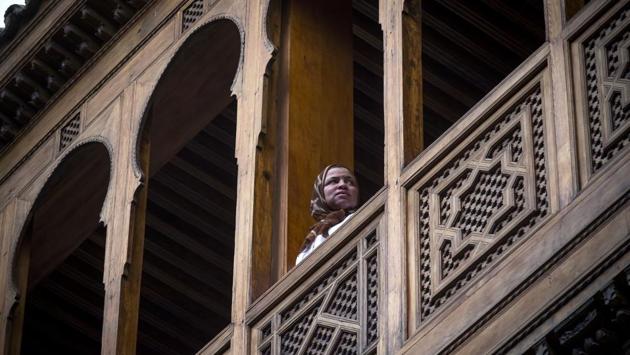 A woman stands in the balcony of a traditional building. In mid-April, King Mohammed VI visited Fez to inaugurate some buildings that had been renovated and launched the second phase of the rehabilitation programme. (Fadel Senna / AFP)