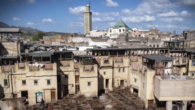 Tourism is a major source of revenue for Morocco, with more than 12 million visitors in 2018. Tourists gather on terraces overlooking the tanneries to snap pictures of the men working below, using the same methods as their ancestors did. The tanners stand almost knee-deep in large vats containing quicklime, cow urine, salt and water to clean the hides, which they later soak in pigeon poop and water before the dying. (Fadel Senna / AFP)