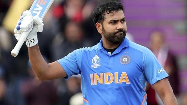India's Rohit Sharma raises his bat to celebrate scoring a century.(AP)