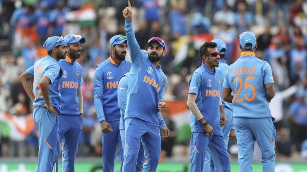 India's captain Virat Kohli, center, dances to celebrate the dismissal of South Africa's Quinton de Kock. (AP)
