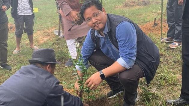Chief Minister Conrad Sangma planting a sapling at Langkyrdem village.(HT Photo) Chief Minister Conrad Sangma planting a sapling at Langkyrdem village.(HT Photo)