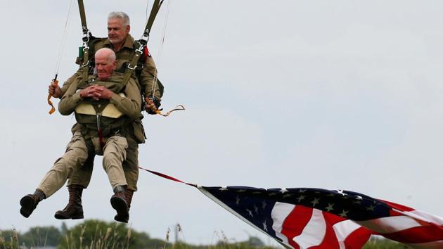 US veteran Tom Rice, 97 years-old who served with the 101st Airbone, lands during a commemorative parachute jump over Carentan on the Normandy coast from a a C-47 aircraft recreating his leap into the unknown where he first saw action in 1944. A group of five Americans parachuted on Wednesday wearing their jumpsuits, all World War II-era uniforms. (Pascal Rossignol / REUTERS)