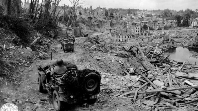 A US Army jeep which came ashore following the D-Day landings, makes its way into the destroyed Normandy town of St-Lo. From the beaches, Allied troops would advance their fight, take Paris in late summer and march in a race against the Soviet Red Army to control as much German territory as possible by the time Adolf Hitler died in his Berlin bunker and Germany surrendered in May 1945. (National Archives of Canada via REUTERS)
