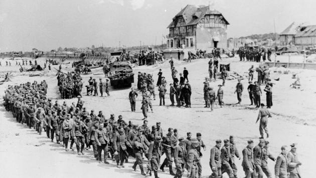 German prisoners-of-war march along Juno Beach to a ship taking them to England, after being captured by Canadian troops at Bernieres Sur Mer on June 6, 1944. The exact German casualties are not known, but historians estimate between 4,000 and 9,000 men were killed, wounded or missing during the invasion. Some 22,000 German soldiers are buried around Normandy. (Ken Bell / National Archives of Canada via REUTERS)